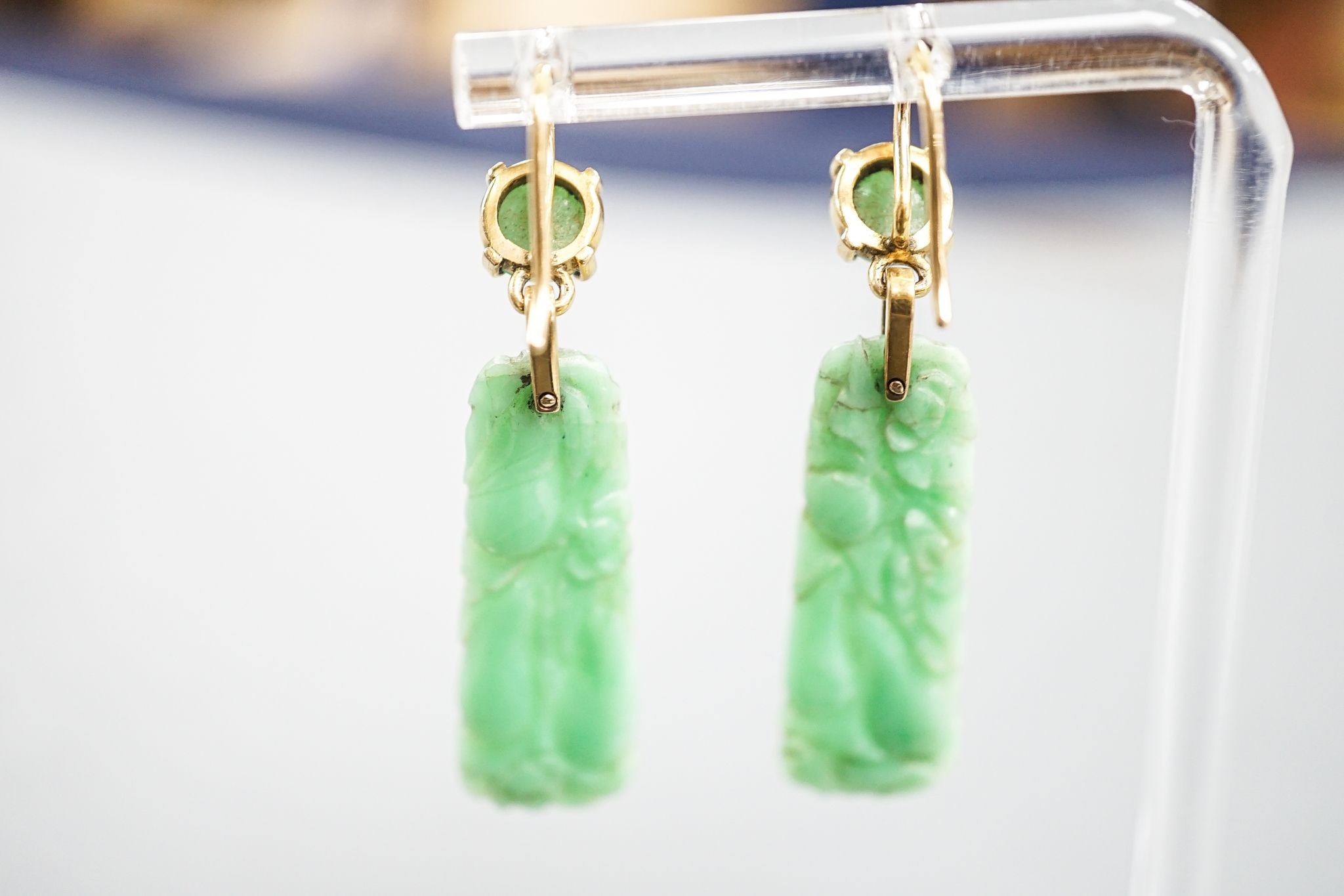 A pair of yellow metal mounted carved jade drop earrings, 43mm, gross 6.8 grams.